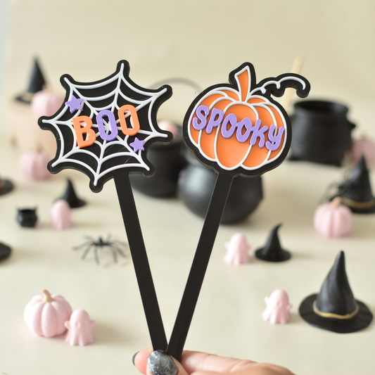 Hand holding two spooky magic wands