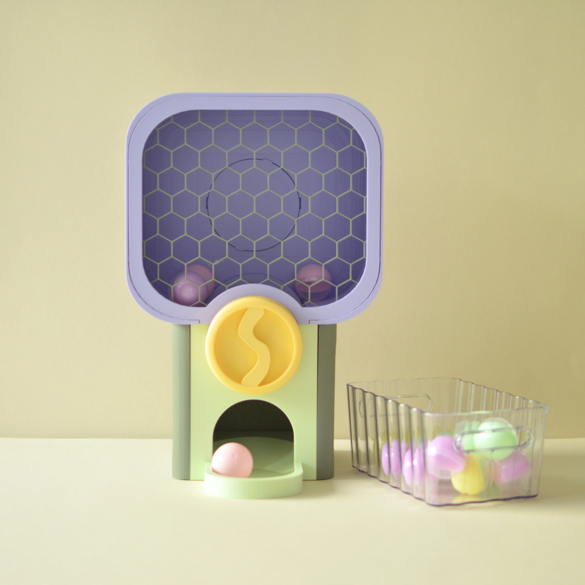 3D printed mini surprise vending machine in Pastel Party colours with a basket of surprise capsules