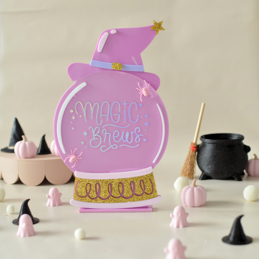 Pink Magic Brews acrylic Halloween sign shaped like a crystal ball with witch hat