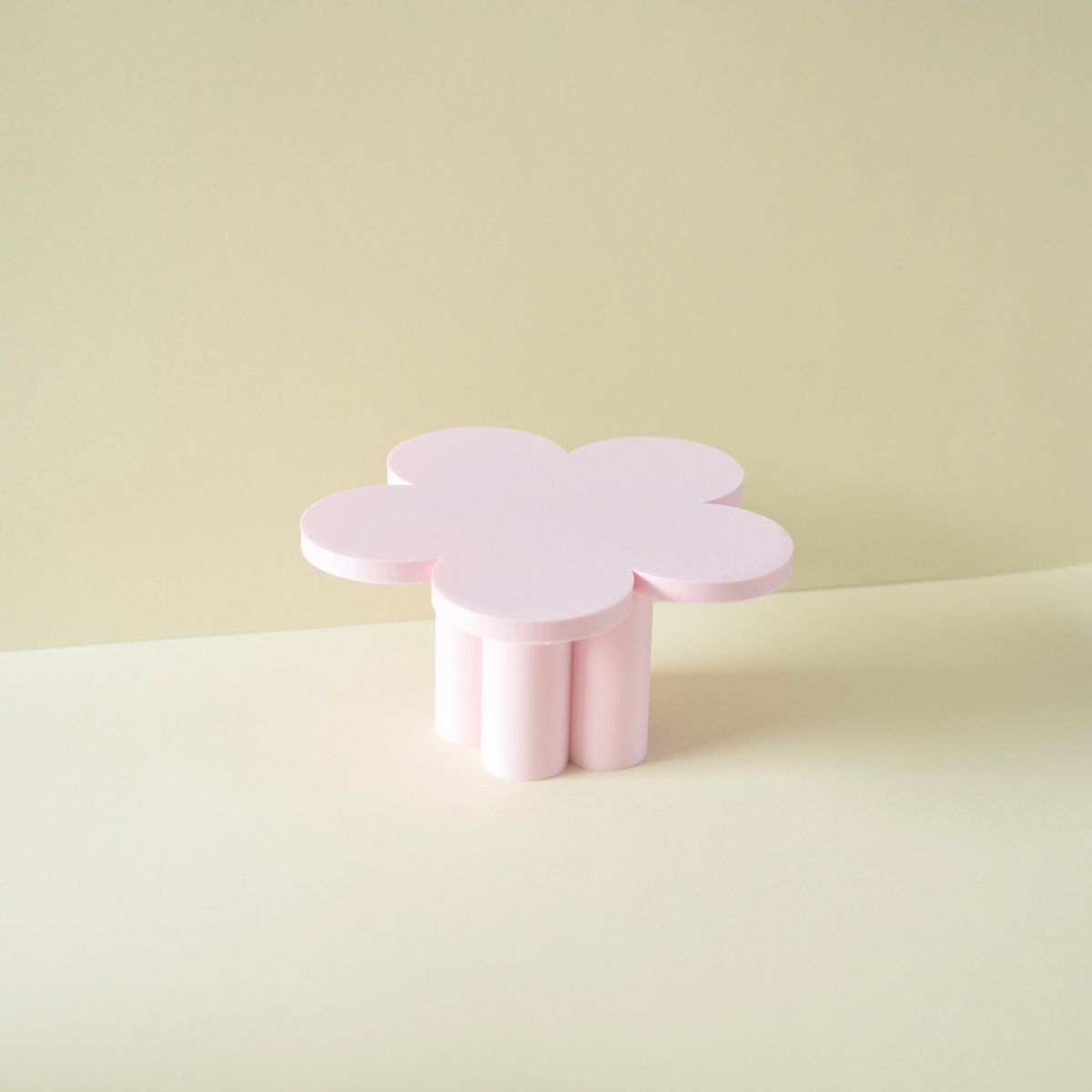 Pastel pink flower cake stand on a light background