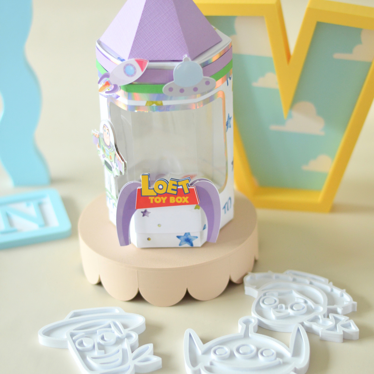 Clear activity box with purple lid on a scalloped stand
