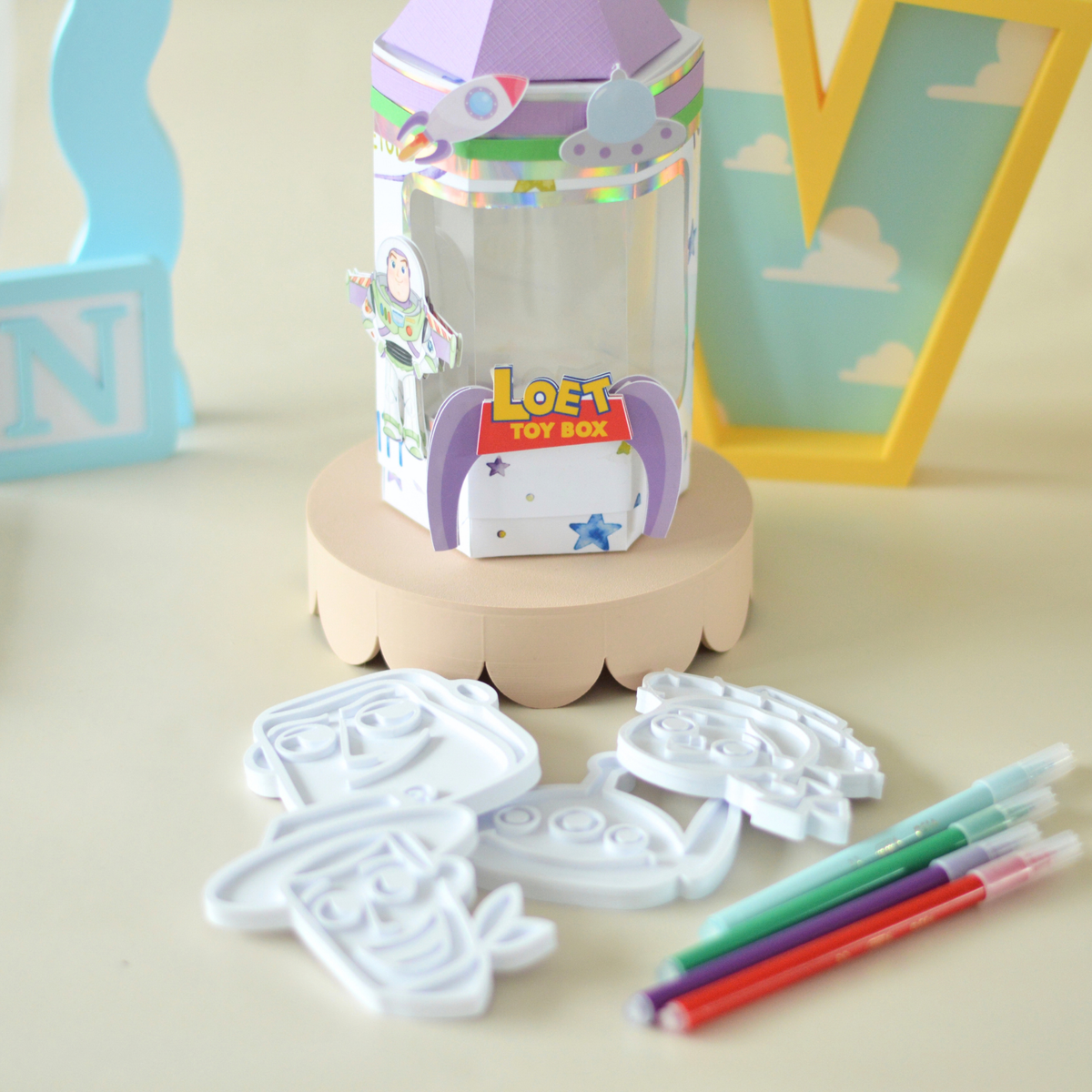 Activity box with colouring plates and pens laid out in front