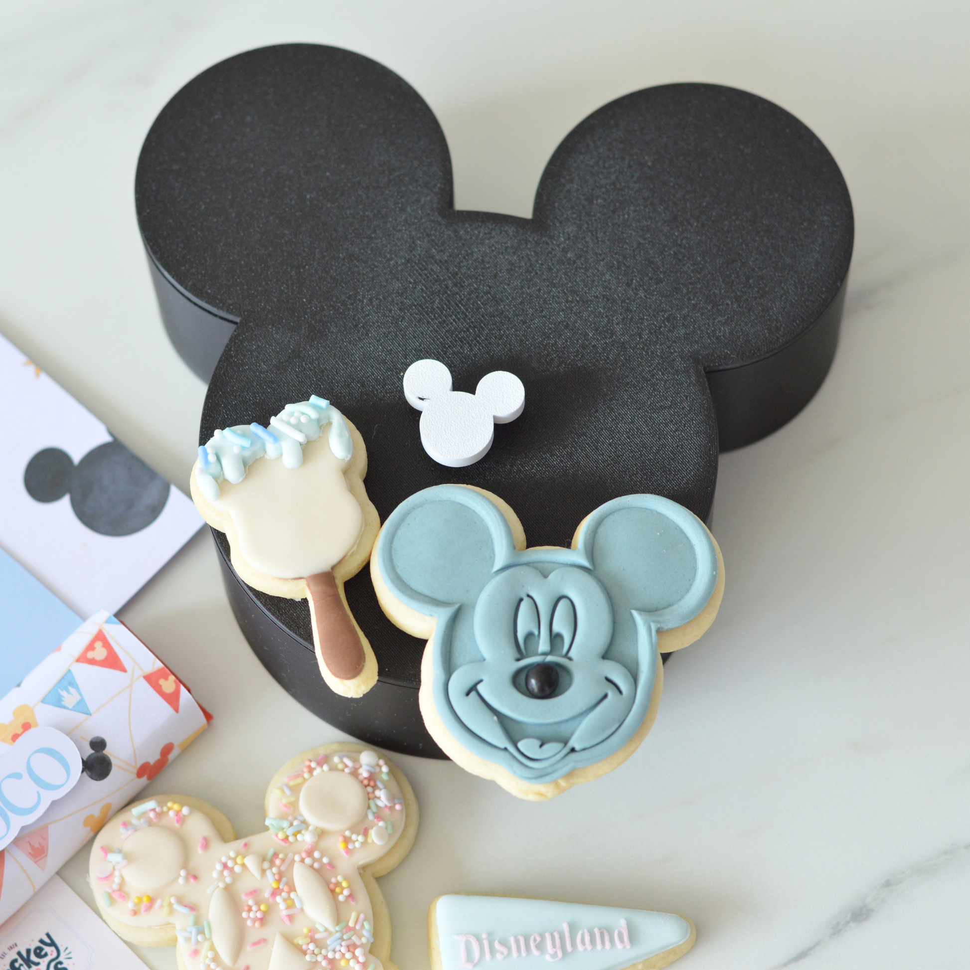 3D Mickey-shaped black birthday gift box close-up by Oh Happy Co.