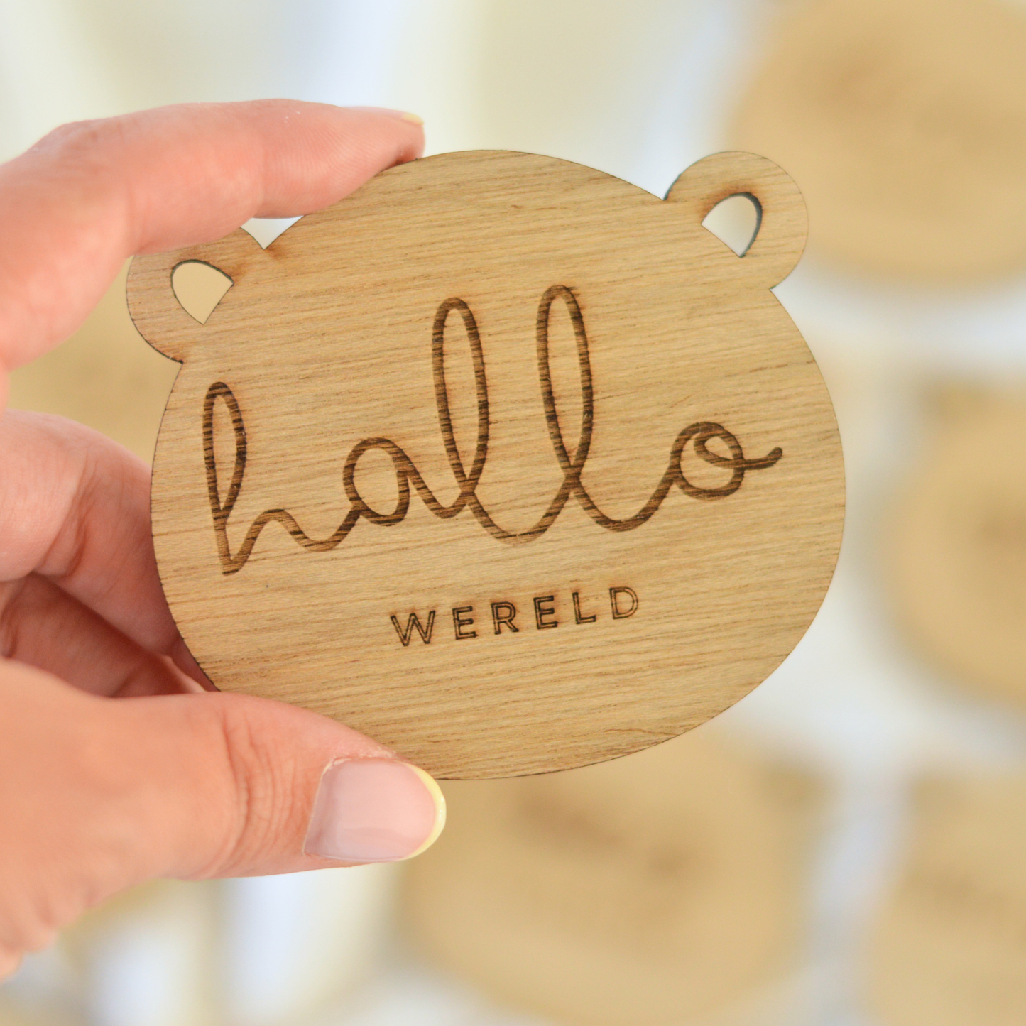 Hand holding wooden bear hallo wereld milestone card — laser engraved, baby keepsake, Oh Happy Co.